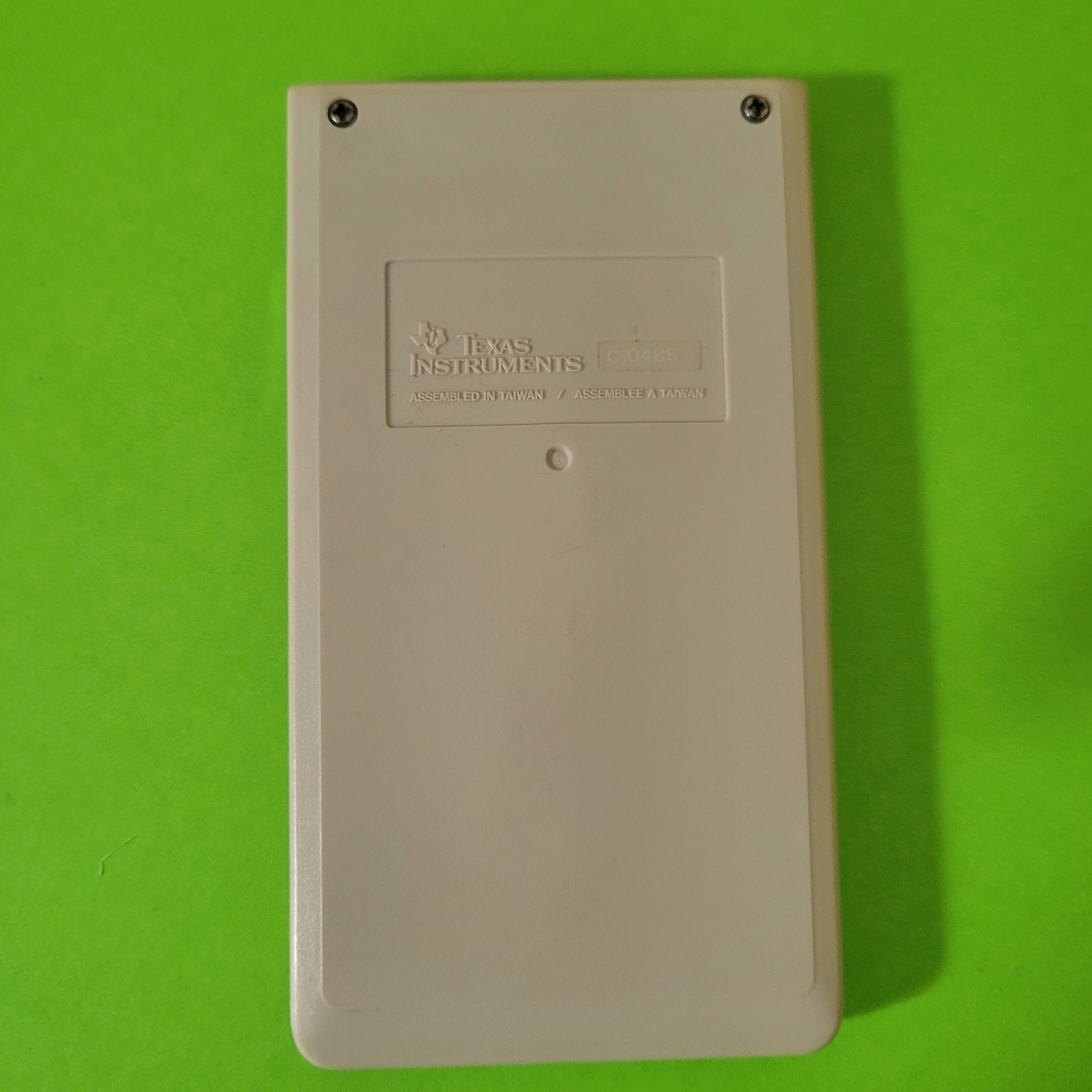 An image of the back of a ti-1706II four function plus calculator